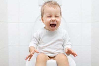 adorable-young-child-sitting-on-the-toilet-PK7Y3LR.jpg