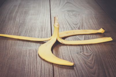 banana-peel-on-the-wooden-table-PMKWDGN.jpg