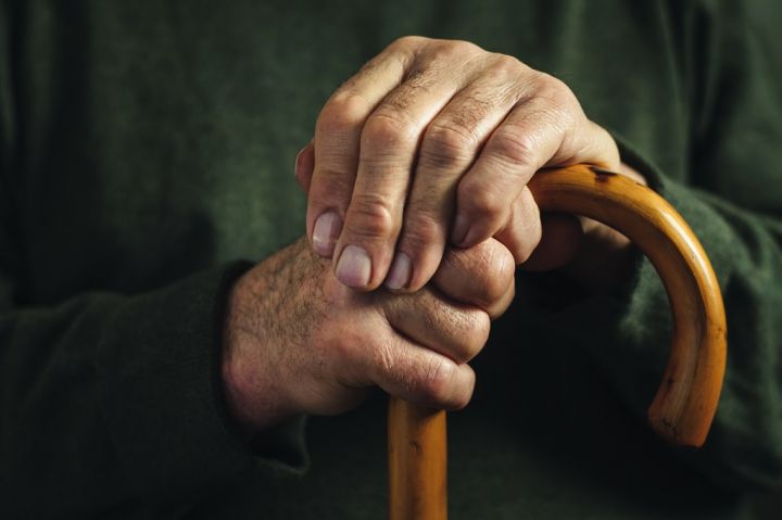 senior-disabled-man-clasping-his-walking-stick-GQC9KVK.jpg