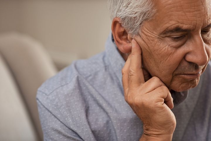 senior-man-with-hearing-problems-68VZQH2.jpg