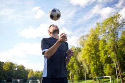 soccer-player-playing-with-ball-on-field-PVCTUM6.jpg